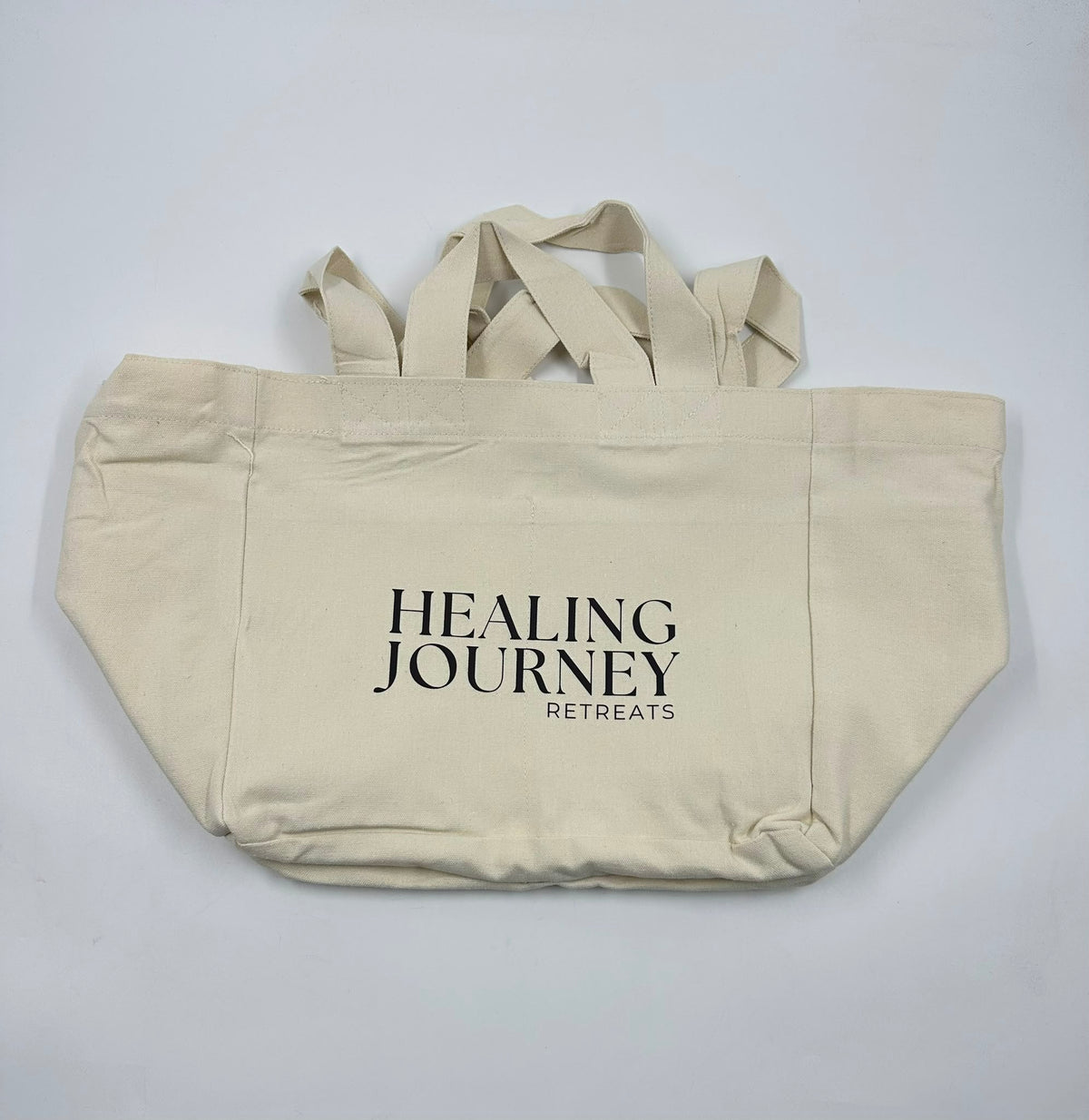 Custom black screen printing on a natural canvas tote bag