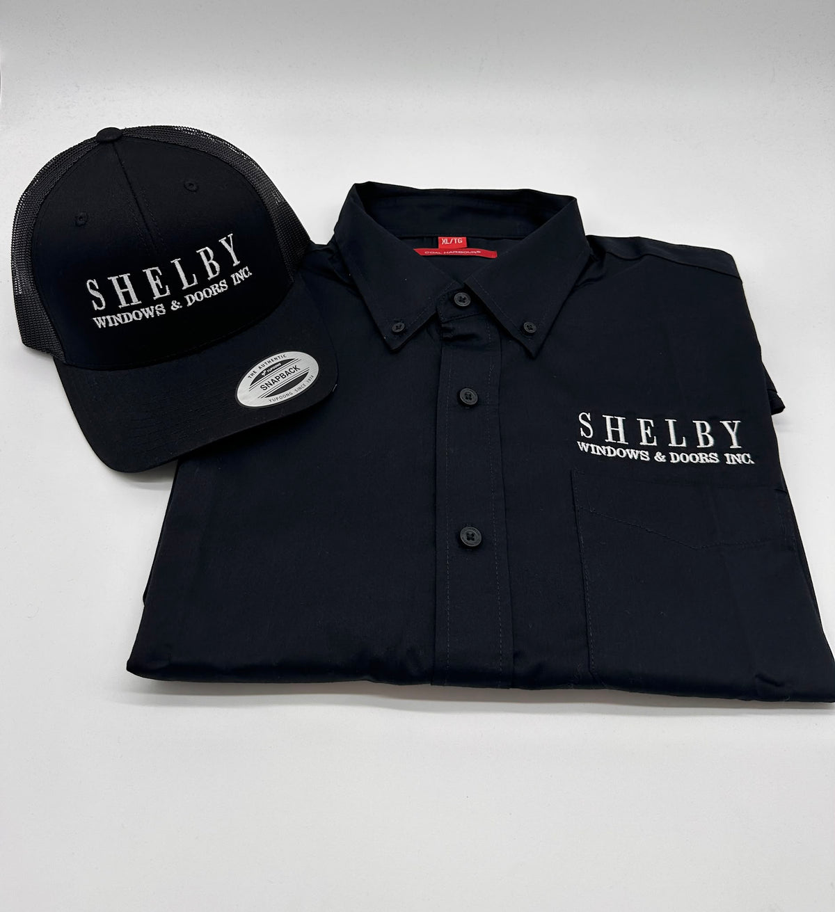 Company logo embroidered on black work shirt and hat